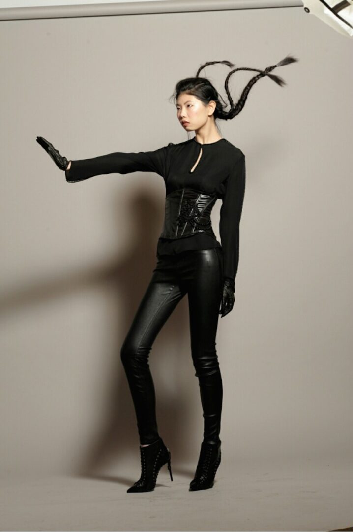 The model is wearing a black outfit with contemporary hairstyling by Dennis from VCI Artists.
