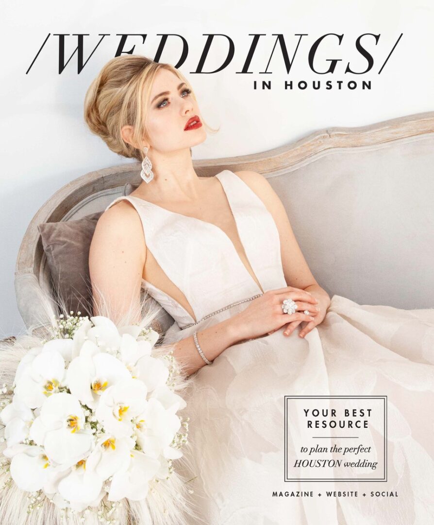 Summer Salah of VCI Artists styles the model with a deep V-neck wedding gown for Wedding Houston magazine